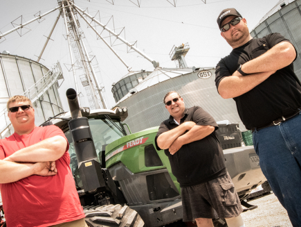 3 Fendt Farmers stand in front of Fendt Track Tractor